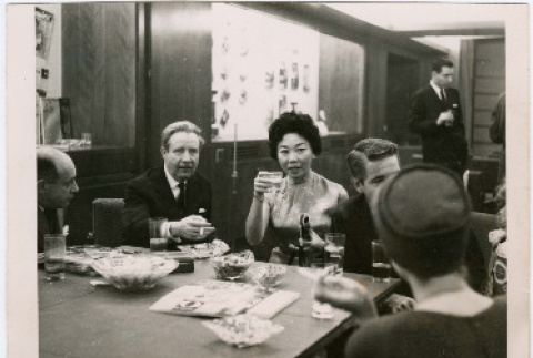 Mary Mon Toy seated at a table in the Esquire offices (ddr-densho-367-306)