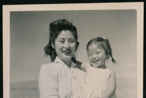 Japanese American woman carries girl toddler with pigtails (ddr-densho-362-48)