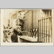 Workers repairing a wrought iron fence (ddr-njpa-13-701)