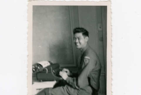 Saburo Arthur Kitagawa sitting at a typewriter (ddr-densho-539-25)