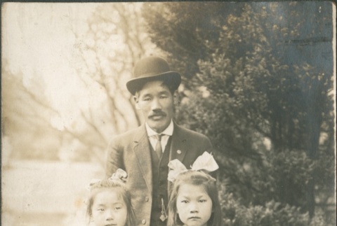 A man with two girls (ddr-densho-321-569)