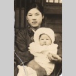 Young woman holding a baby (ddr-njpa-4-2622)