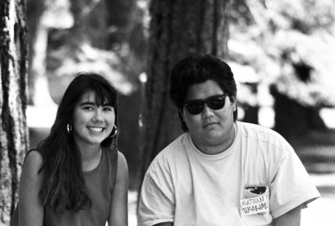 Carolyn Aoki and Nate Takarabe sitting on a fence (ddr-densho-336-1931)