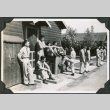 Group of men lined up outside building (ddr-ajah-2-506)