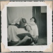 Two young women lounge with books (ddr-densho-321-235)