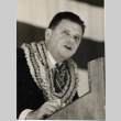 A man wearing leis giving a speech (ddr-njpa-1-1251)