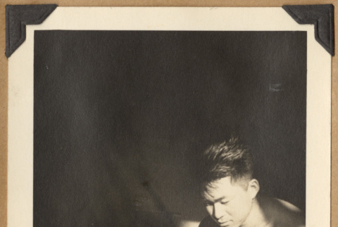 Man reading in a sunbeam (ddr-densho-542-147)
