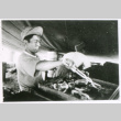 Grilling in tent (ddr-densho-1007-762)