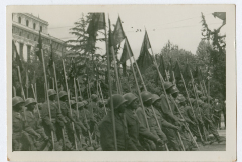 Soldiers with flags marching in city street (ddr-densho-368-97)