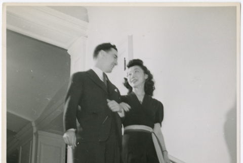 Mary Mon Toy and unidentified man walking down staircase (ddr-densho-488-7)