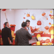 Three men looking at enamel ware display (ddr-densho-426-367)