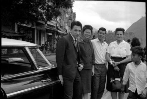 Two women, two men and a boy standing by car (ddr-densho-426-2400)