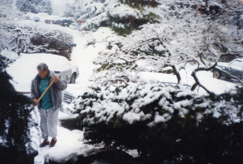 Tom Kubota sweeping snow in the Garden (ddr-densho-354-408)