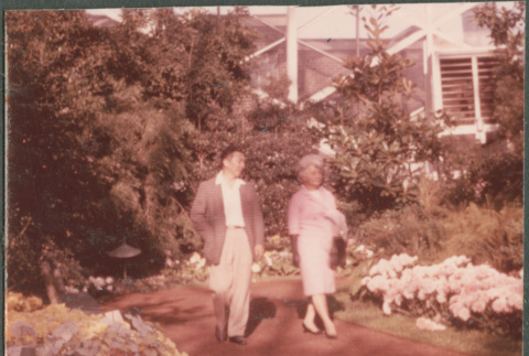 Agnes Sakura and man walking on garden path (ddr-densho-523-443)