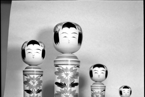Four wooden figures on display (ddr-densho-426-2212)