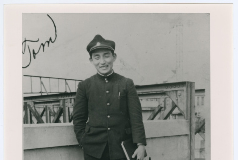 Person in uniform holding book (ddr-densho-1007-29)