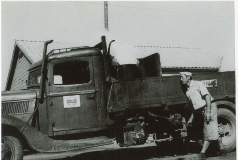 Japanese man fueling up a truck (ddr-densho-299-117)