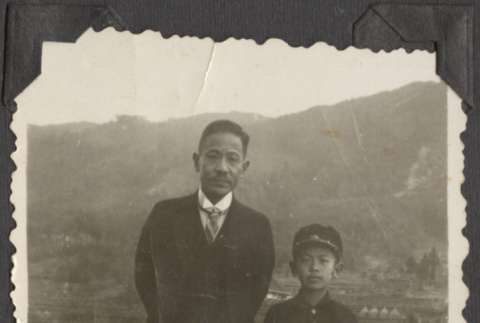 A man and boy with farmland in the background (ddr-densho-432-110)