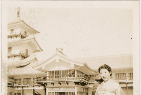 Woman standing by railing at Japanese Pavilion at the Golden Gate International Exposition (ddr-densho-426-1988)