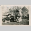 Two women in a park with a dog (ddr-densho-328-27)