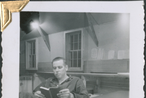 Man sitting at desk reading (ddr-densho-434-232)