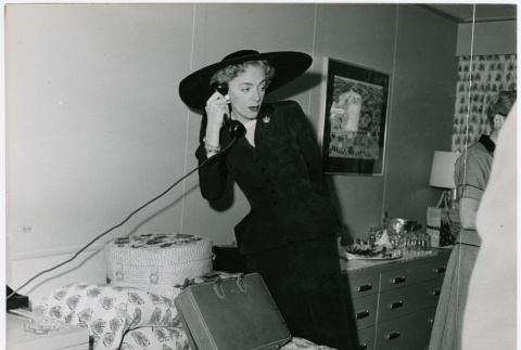 Christine Jorgenson on the phone in stateroom (ddr-densho-367-165)