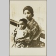 A woman sitting with her son in her lap (ddr-njpa-13-1248)