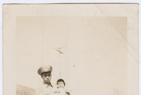 Man in uniform holding child (ddr-densho-316-109)