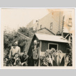 Tomoye (Nozawa) Takahashi and Tomoyuki Nozawa with two unidentified men in garden (ddr-densho-426-2129)