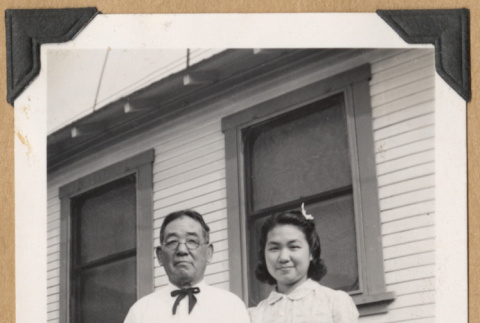 Man and young woman by a picket fence (ddr-densho-542-213)
