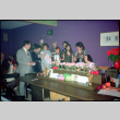 Group standing around piano, singing (ddr-densho-426-603)