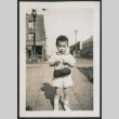 Photo of a child holding a purse (ddr-densho-483-718)