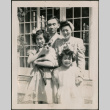 Family photo with man, woman and two girls, one holding a cat (ddr-densho-316-421)