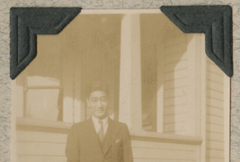 Bob Higashida in suit outside house (ddr-densho-383-279)