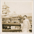 Woman standing by railing at Japanese Pavilion at the Golden Gate International Exposition (ddr-densho-426-1988)
