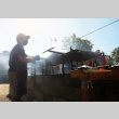 Man cooking at grill (ddr-densho-512-21)