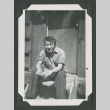 Man sitting on steps (ddr-densho-471-182)