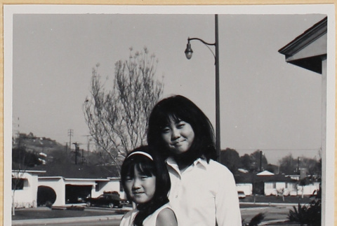 Two girls outside house (ddr-densho-522-126)