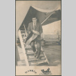 Photo postcard of man getting off plane (ddr-densho-523-375)