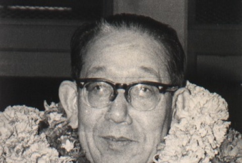 Kunizo Matsuo wearing leis (ddr-njpa-4-886)