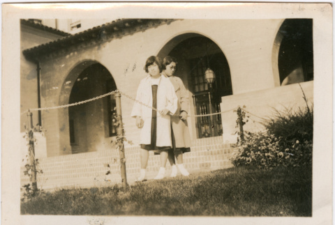 Two women standing in front of building (ddr-densho-423-557)