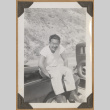 Man sitting on a car (ddr-densho-542-89)