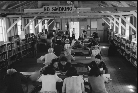 Japanese Americans reading in library (ddr-densho-151-353)
