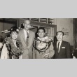 Consolidated Amusement Co. president and employee posing with Japanese actors (ddr-njpa-2-969)