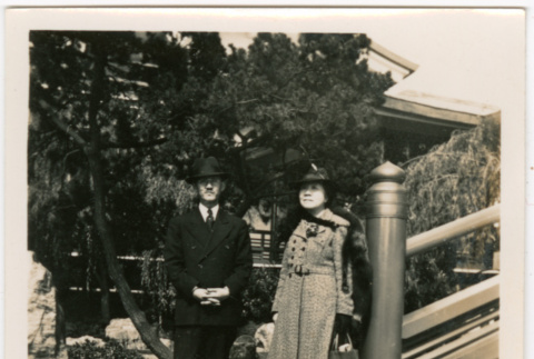 Man and woman standing by stairs in garden (ddr-densho-426-2139)