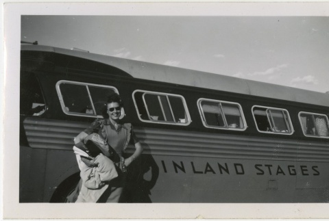 Woman standing in front of a bus (ddr-manz-7-58)