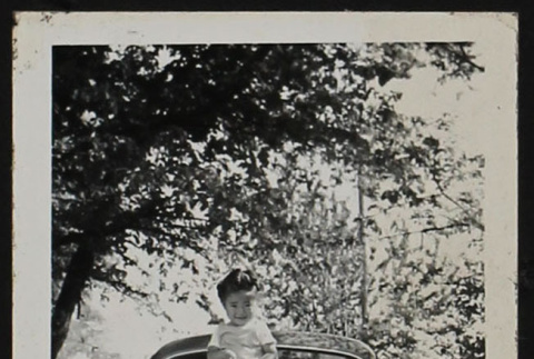 Child on hood of a car (ddr-densho-287-404)