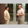 William Kochiyama and Robert H. Foote meeting and walking through barn (ddr-densho-1007-1517)