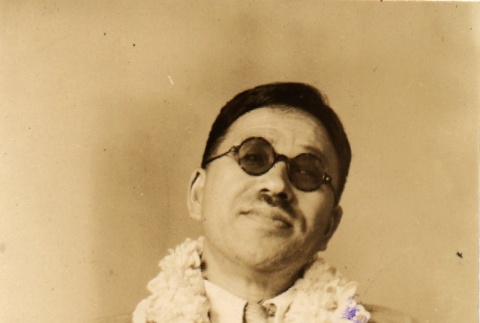 Kanichi Niisato, a blind author wearing leis (ddr-njpa-4-1399)