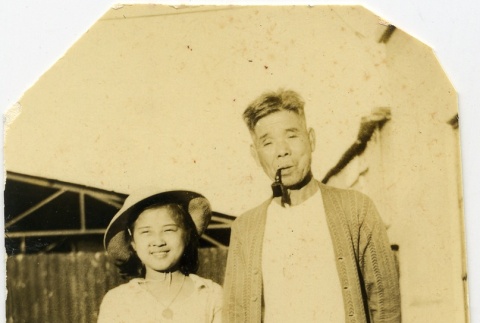 A man with a pipe and a girl with a purse (ddr-densho-22-340)